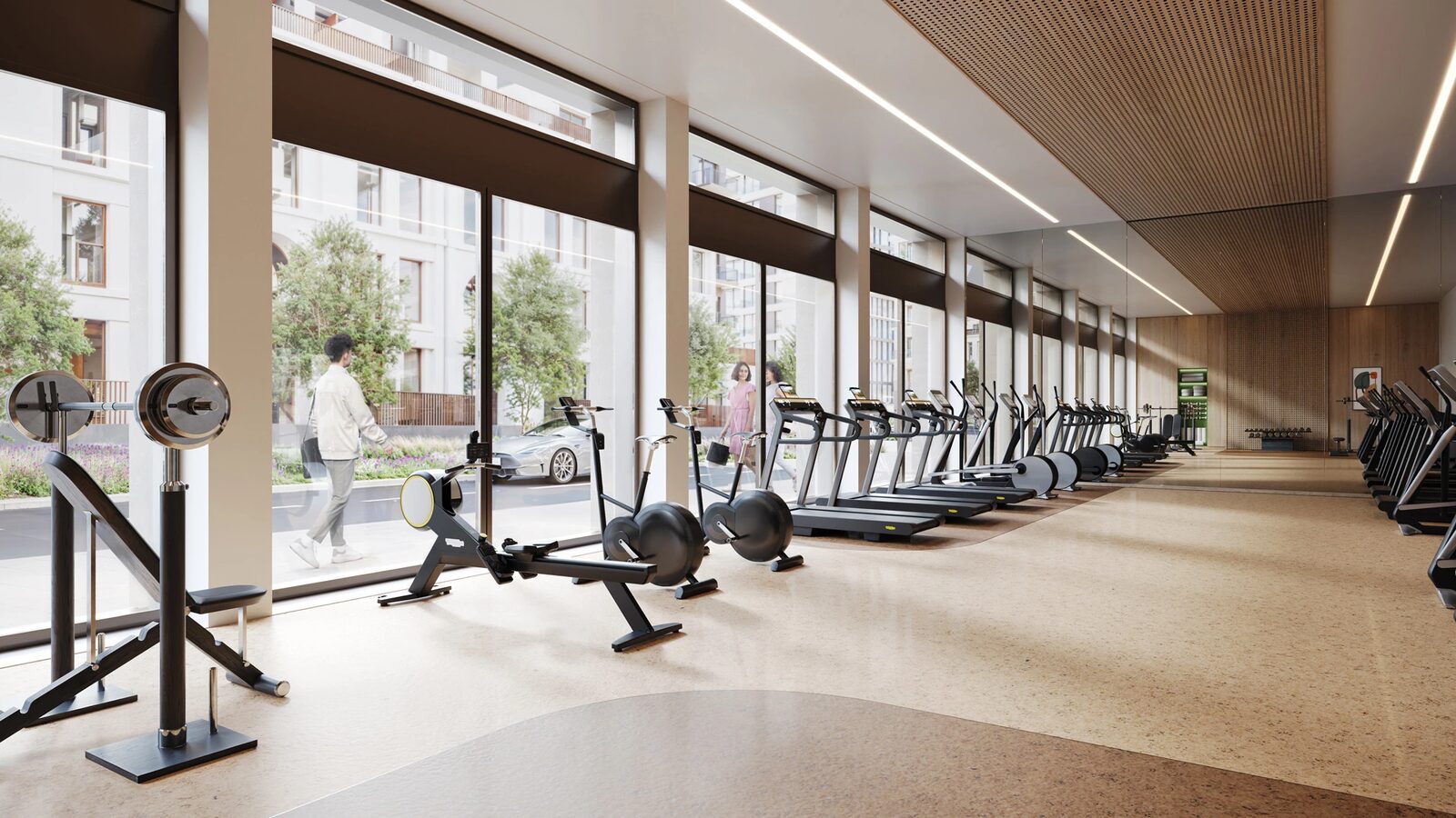 Fitness gym with cardio and strength equipment overlooking the street